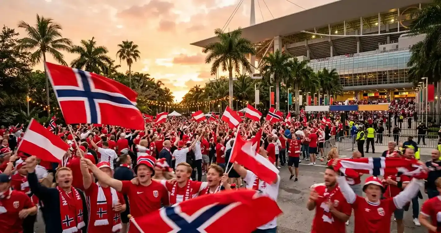 Norska fotbollsfans i rött och vitt viftar med flaggor utanför en arena i tropiskt klimat